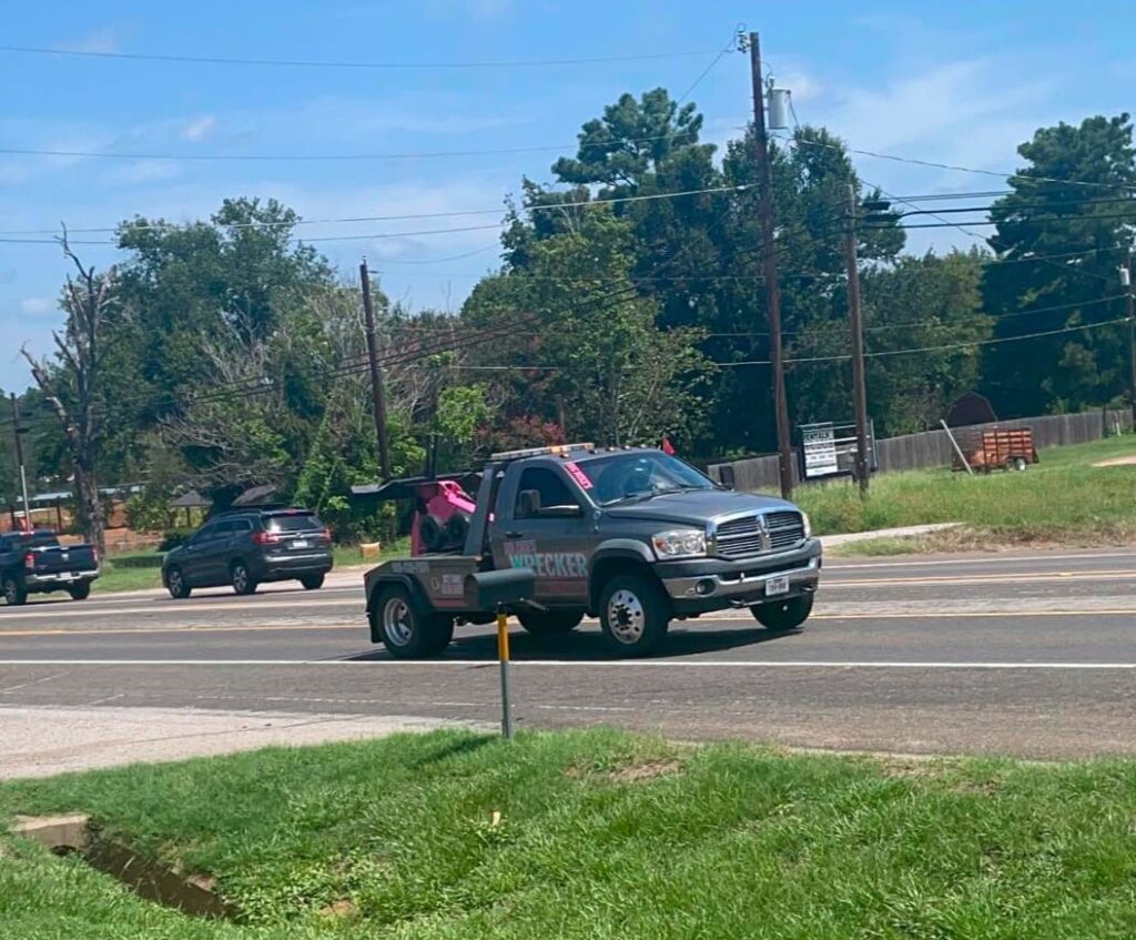 Big Mike’s Wrecker Service roadside assistance truck driving in Palestine Texas