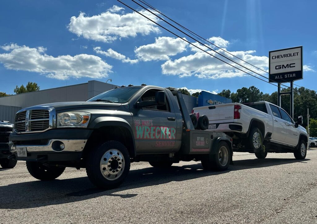 Big Mike’s Wrecker Service roadside towing service moving white pickup truck in Palestine TX