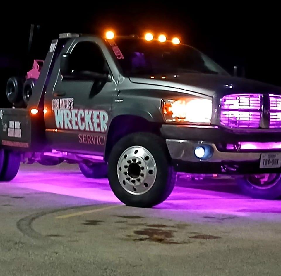 Big Mike’s Wrecker Service tow truck with emergency lights at night in Palestine TX