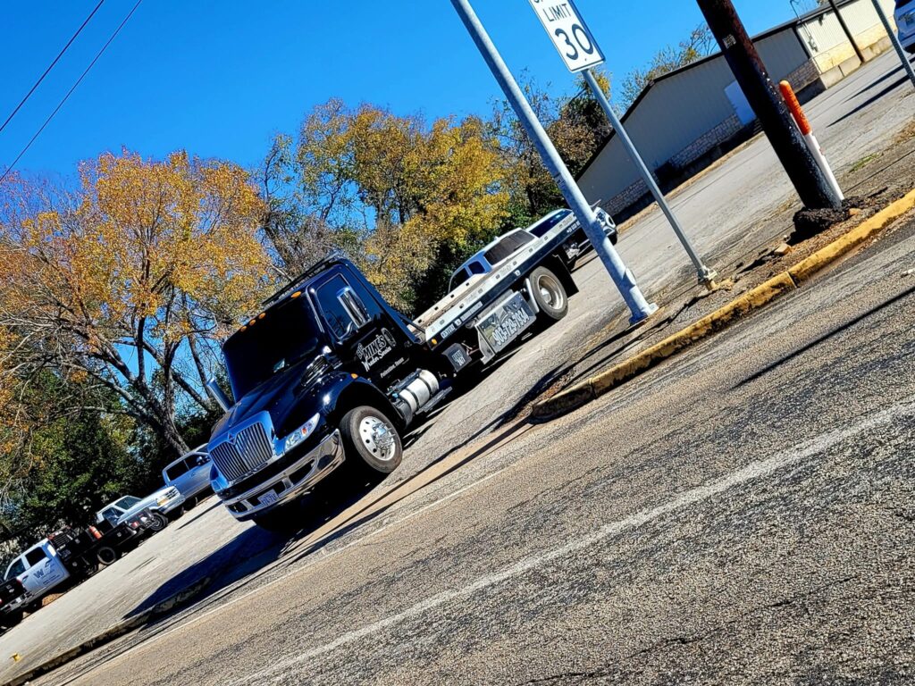 Big Mike’s Wrecker Service flatbed tow truck parked near roadway in Palestine TX
