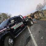 Big Mike’s Wrecker Service performing accident recovery for overturned SUV on roadside