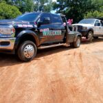 Big Mike’s Wrecker Service towing a work dump truck with heavy-duty wheel lift in Palestine Texas