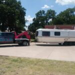 Big Mike’s Wrecker Service tow truck towing a travel trailer in Palestine TX