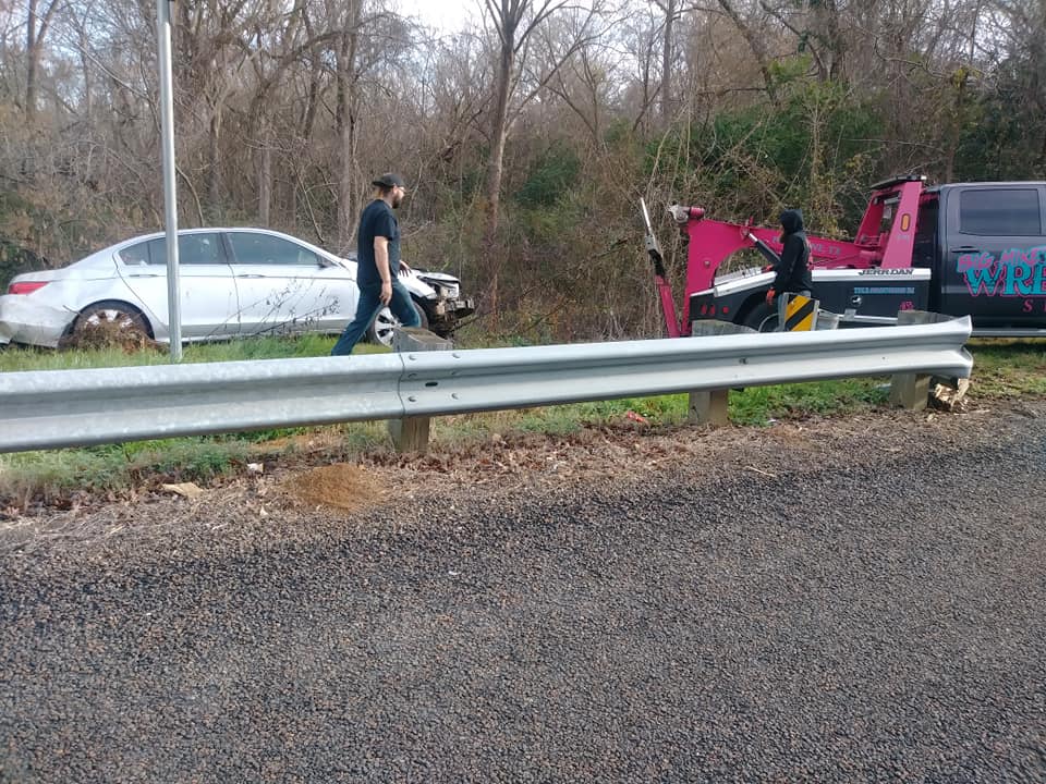 Big Mike’s Wrecker Service recovering a crashed sedan from roadside ditch in Palestine TX