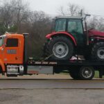 Big Mike’s Wrecker Service heavy equipment towing with tractor on flatbed