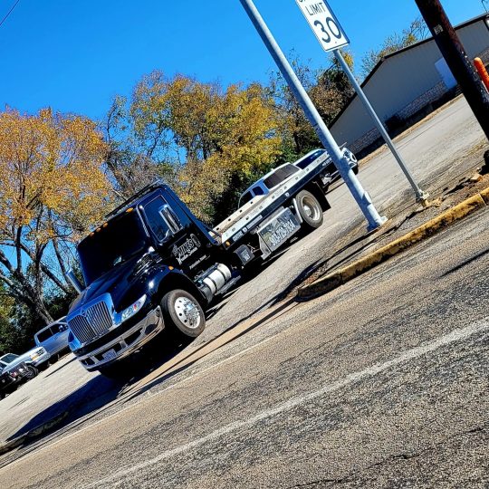 Big Mike’s Wrecker Service flatbed tow truck parked near roadway in Palestine TX
